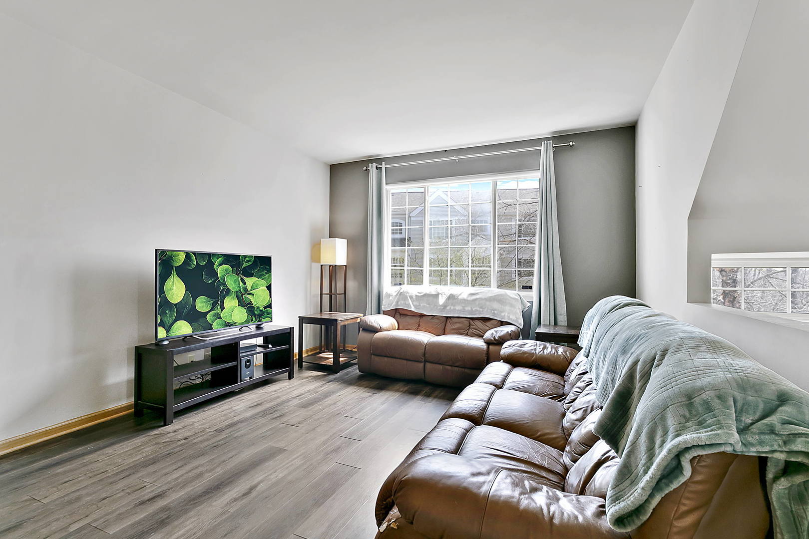 3459 Ravinia Circle, Unit 3459 Aurora, IL 60504 - Photo 4 of 18 a living room with furniture and a flat screen tv