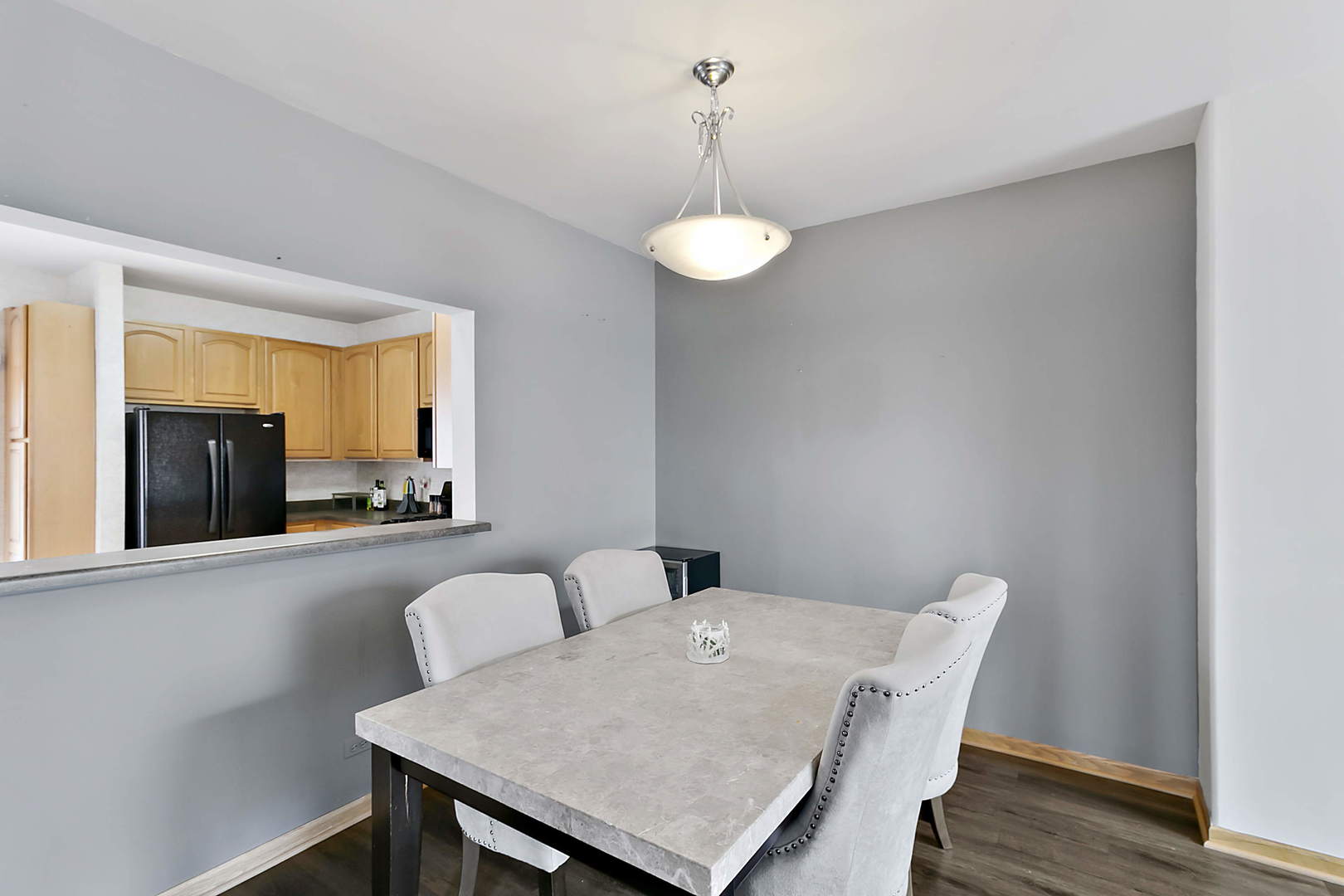3459 Ravinia Circle, Unit 3459 Aurora, IL 60504 - Photo 6 of 18 a view of a dining room with furniture and wooden floor