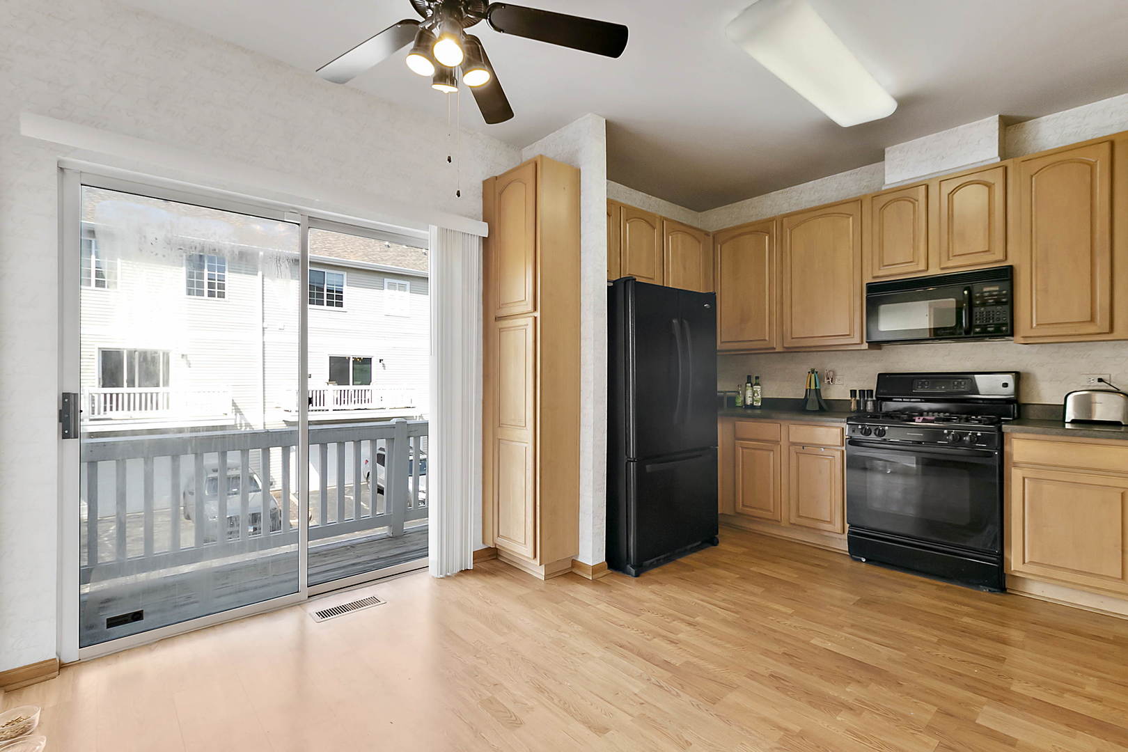 3459 Ravinia Circle, Unit 3459 Aurora, IL 60504 - Photo 8 of 18 a kitchen with stainless steel appliances granite countertop a refrigerator a stove a sink and a microwave