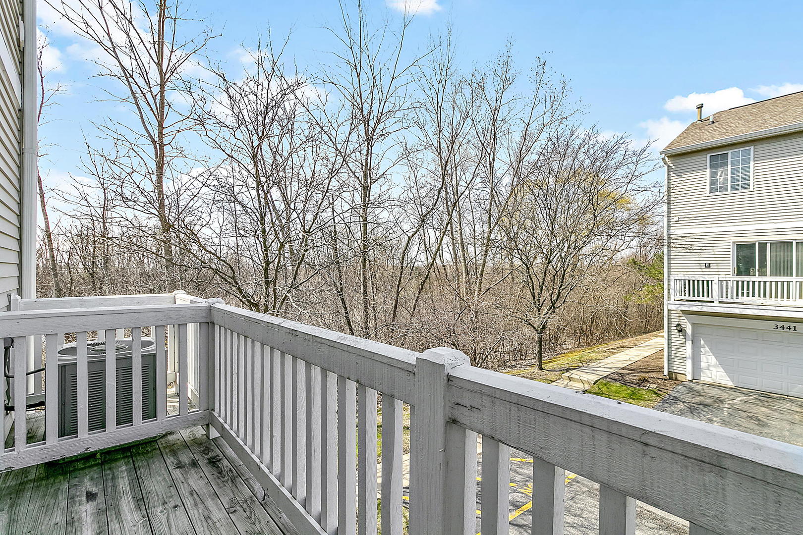 3459 Ravinia Circle, Unit 3459 Aurora, IL 60504 - Photo 9 of 18 a view of a wooden deck and a yard with wooden fence