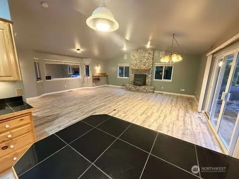 a view of kitchen with granite countertop window