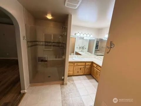 a bathroom with a mirror sink and tub