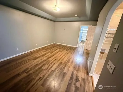 a view of empty room with wooden floor