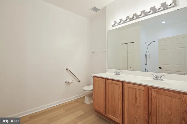 a bathroom with a sink a toilet and mirror