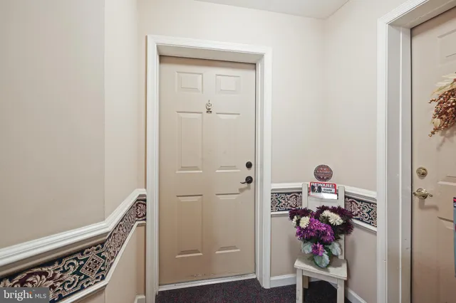 a view of room with wooden floor and stairs