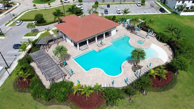 an aerial view of a house with yard swimming pool and outdoor seating