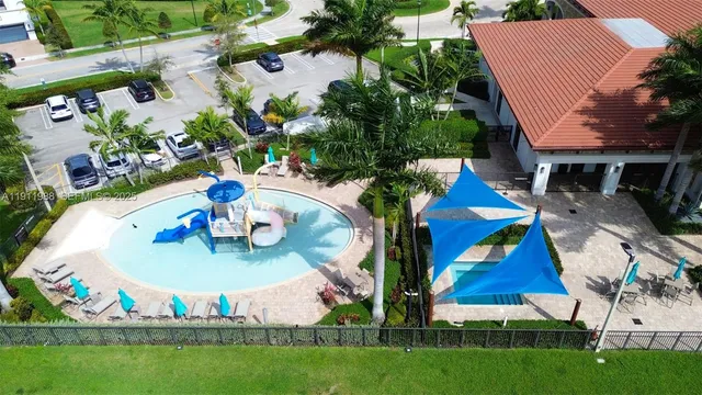 an aerial view of a house outdoor space and swimming pool