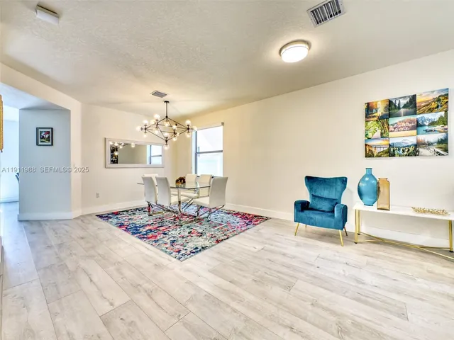 a bedroom with a bed and a table chair