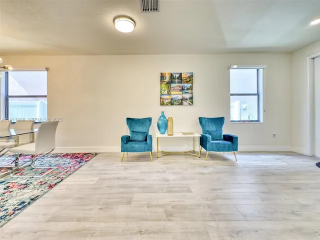 a bedroom with furniture and a lamp