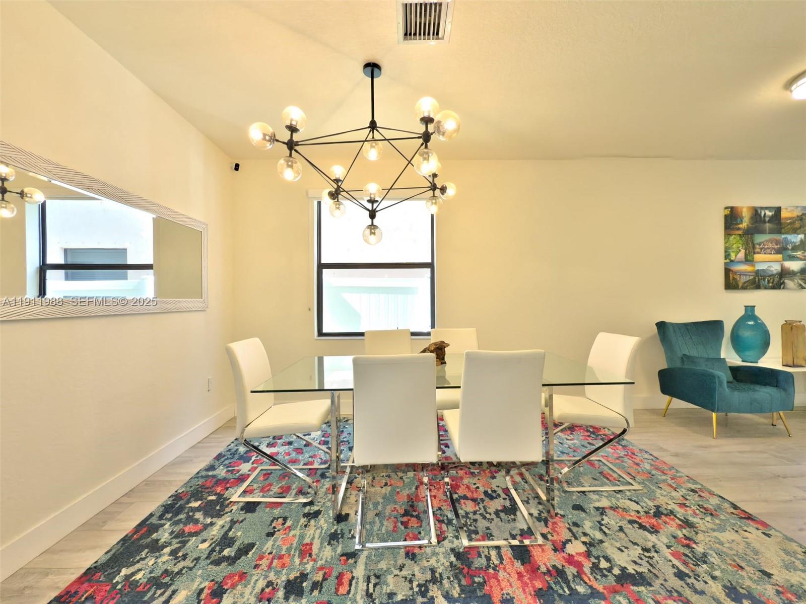 10583 West 35th Way, Unit 10583 Hialeah, FL 33018 - Photo 24 of 48 a living room with a couch and a table