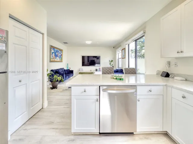 a kitchen with cabinets and window