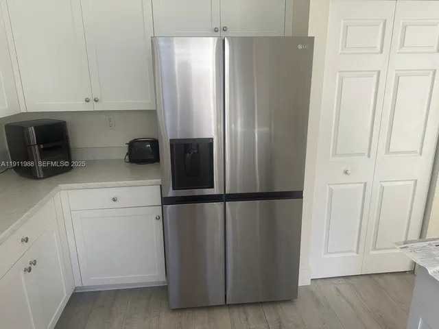 a kitchen with appliances and cabinets