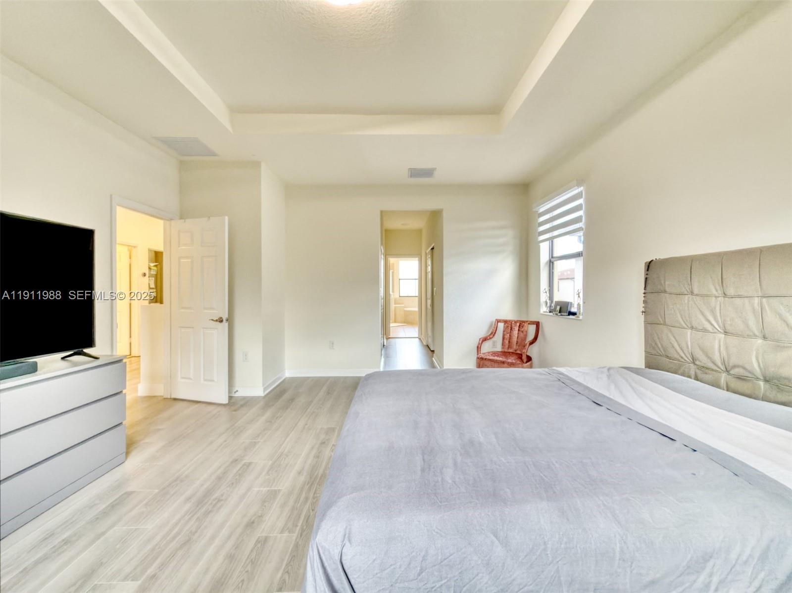 10583 West 35th Way, Unit 10583 Hialeah, FL 33018 - Photo 42 of 48 a large bedroom with a bed and a flat screen tv