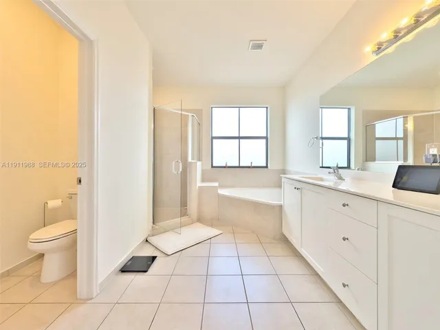 a spacious bathroom with a bathtub sink and toilet