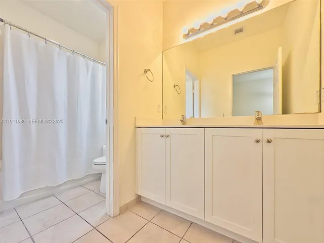 a bathroom with a shower and a mirror