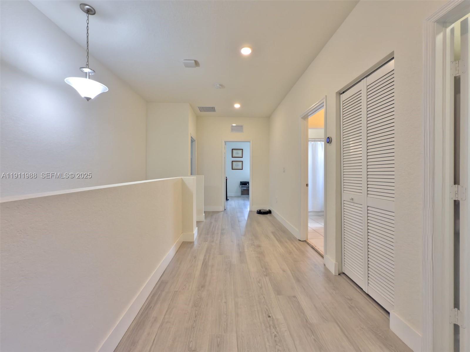 10583 West 35th Way, Unit 10583 Hialeah, FL 33018 - Photo 46 of 48 a view of hallway with wooden floor