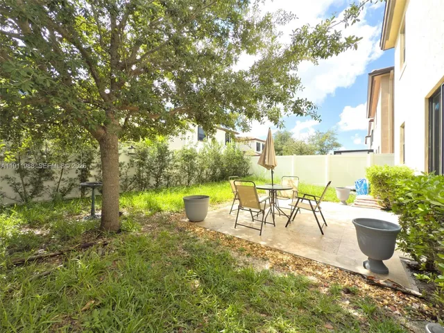 a view of a swimming pool with a patio and a yard