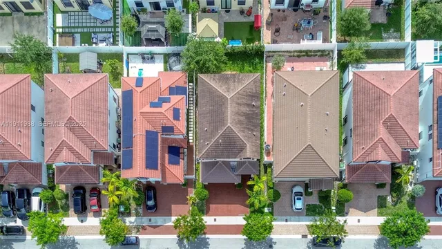 an aerial view of multiple houses with a yard