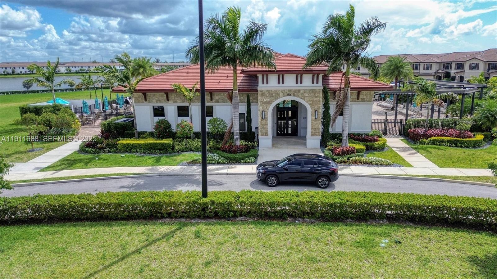 10583 West 35th Way, Unit 10583 Hialeah, FL 33018 - Photo 8 of 48 a front view of a house with a yard table and chairs