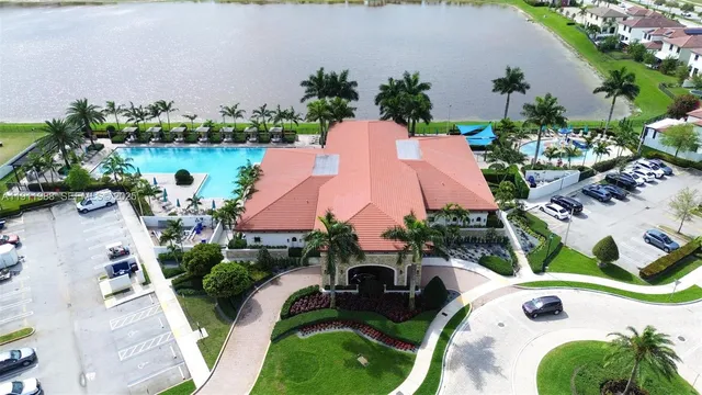 an aerial view of a house with garden space and lake view