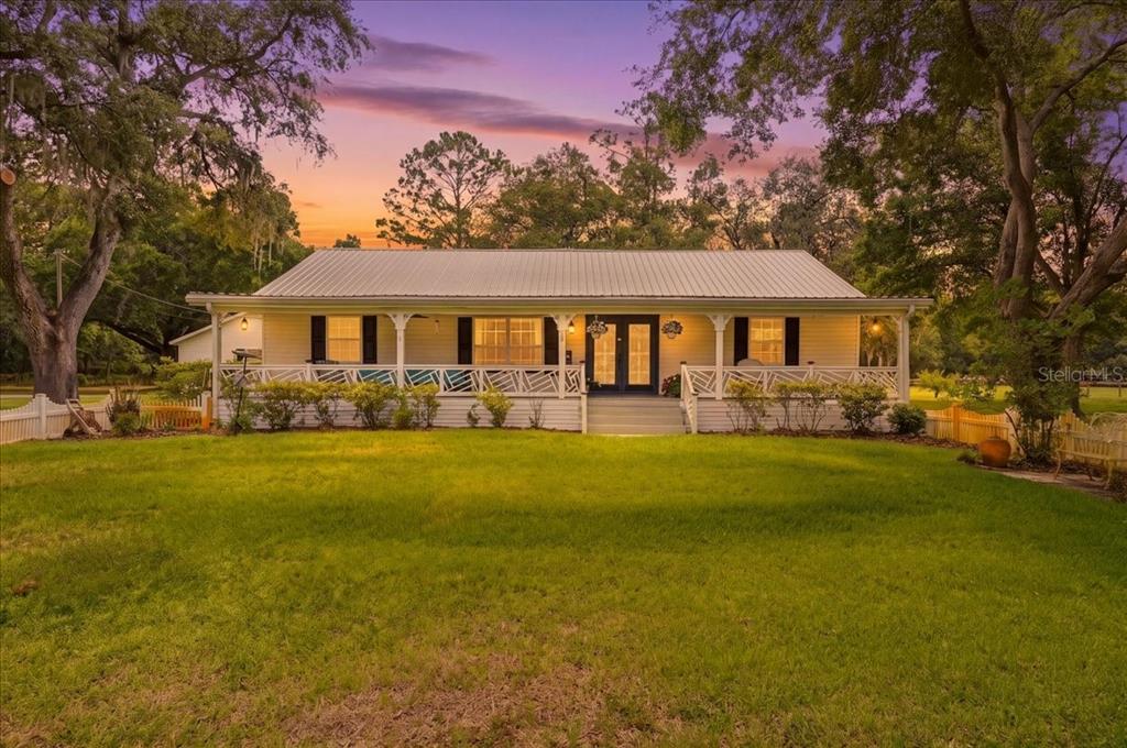 2910 Fritzke Road Dover, FL 33527 - Photo 14 of 100 a front view of a house with a garden and lake view