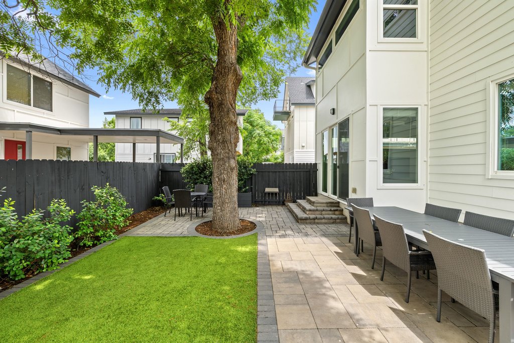 1182 Ridgeway Drive, Unit A Austin, TX 78702 - Photo 33 of 35 a view of a patio with table and chairs potted plants and large tree