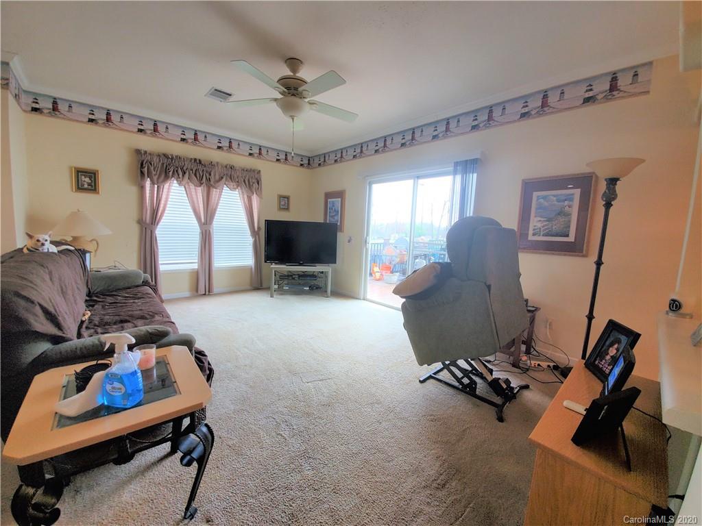 340 Weaver Road Salisbury, NC 28147 - Photo 17 of 23 a living room with furniture gym equipment and a window
