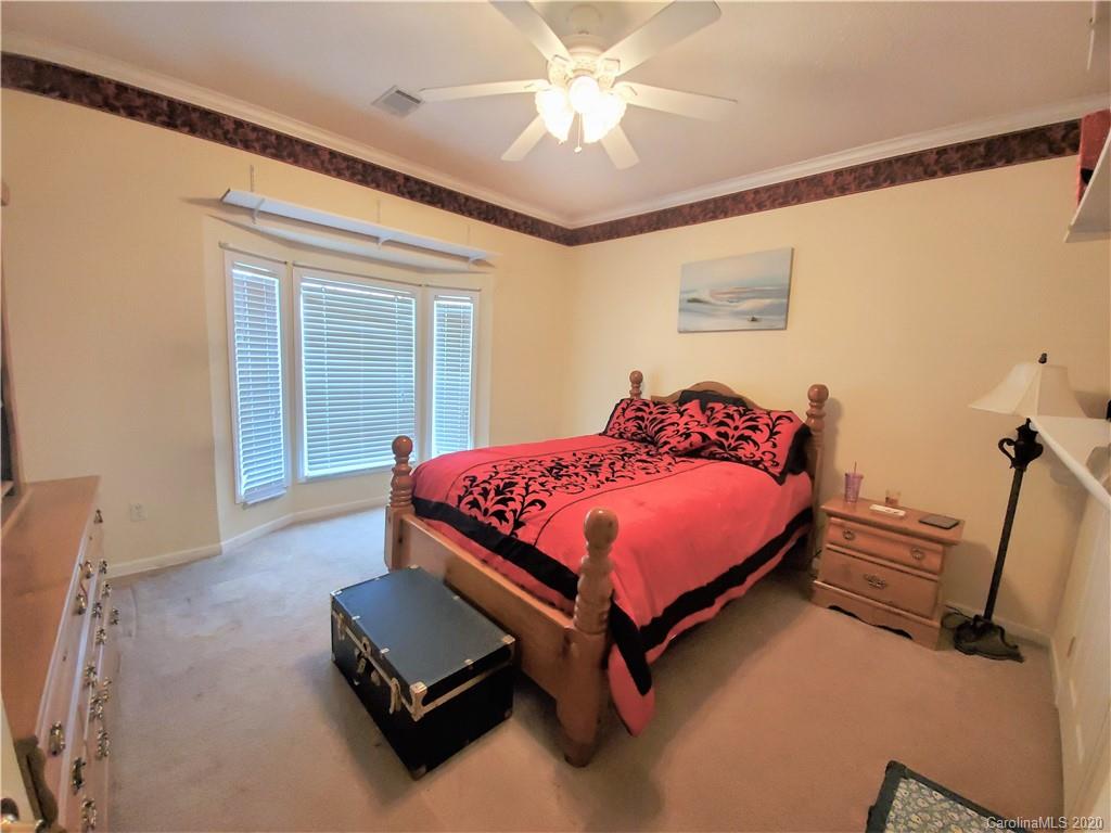 340 Weaver Road Salisbury, NC 28147 - Photo 18 of 23 a bedroom with a bed and a chandelier