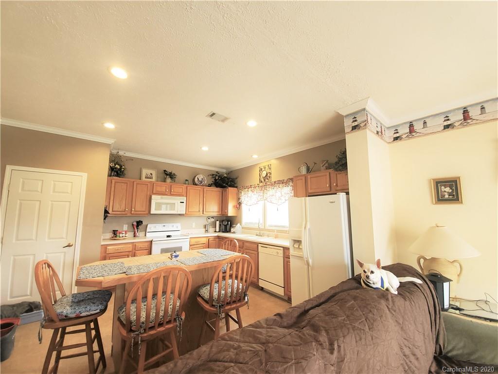 340 Weaver Road Salisbury, NC 28147 - Photo 20 of 23 a kitchen with a table chairs refrigerator and a sink