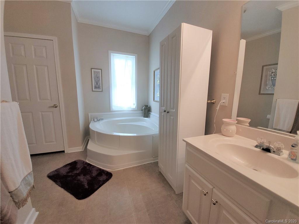 340 Weaver Road Salisbury, NC 28147 - Photo 9 of 23 a bathroom with a tub sink and mirror