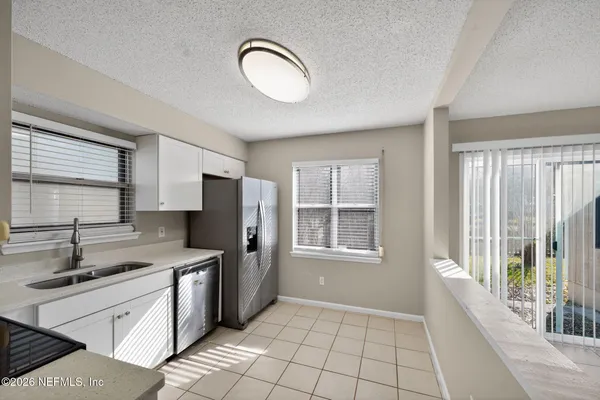 a kitchen with stainless steel appliances granite countertop a sink and a stove