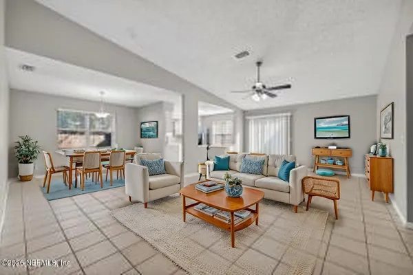 a living room with furniture and a chandelier