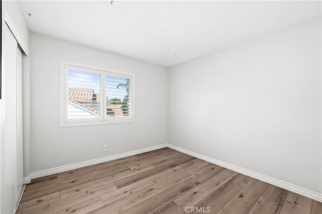 19465 Kinnow Lane Riverside, CA 92508 - Photo 31 of 61 an empty room with wooden floor and windows