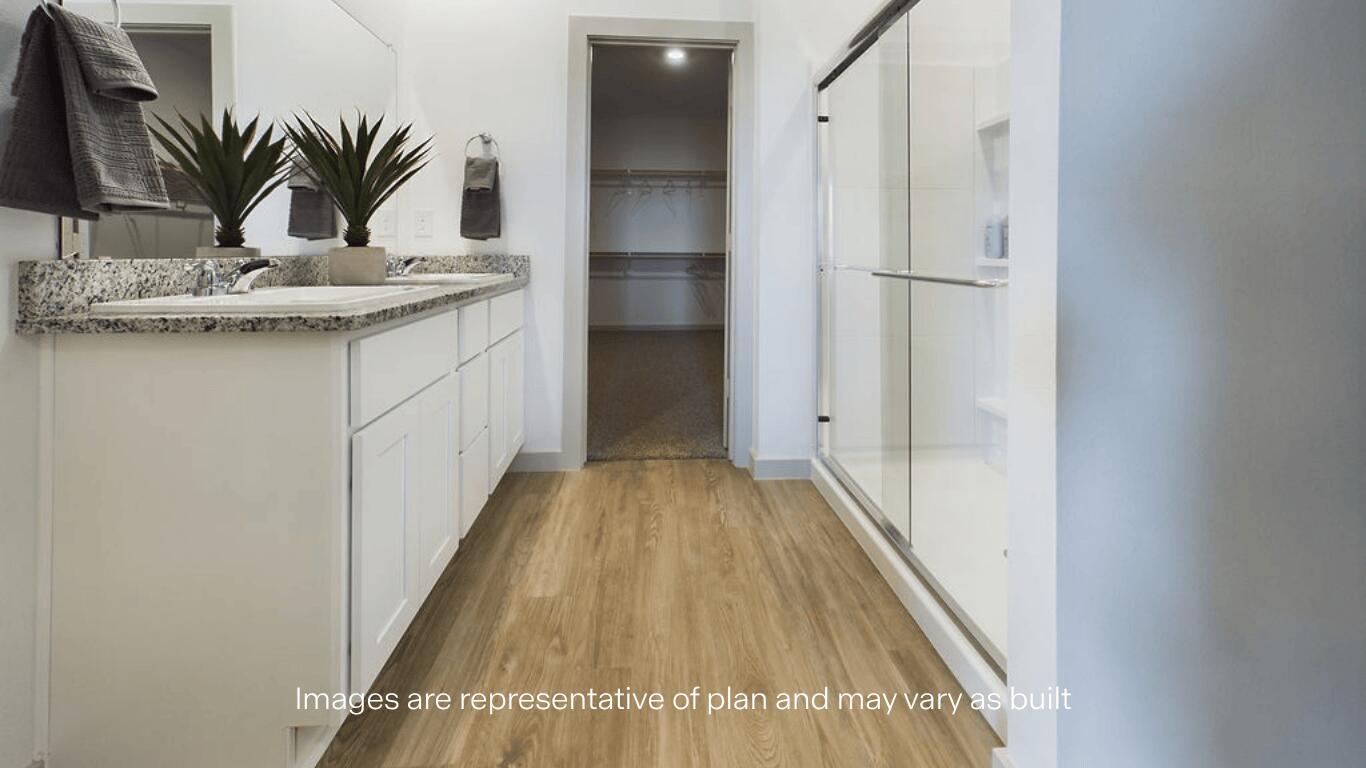 7450 9th Street Lubbock, TX 79416 - Photo 11 of 23 a view of a hallway with wooden floor and a potted plant