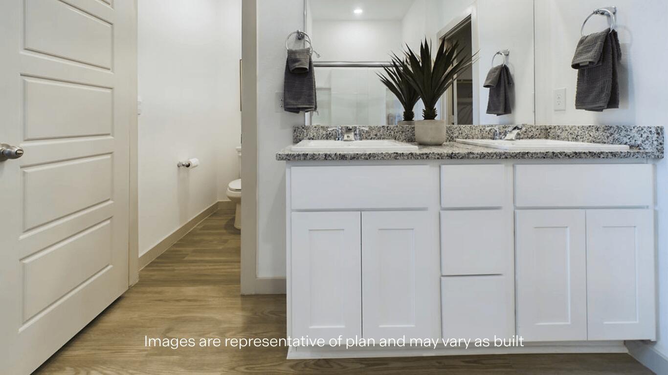 7450 9th Street Lubbock, TX 79416 - Photo 12 of 23 a bathroom with a sink and a mirror