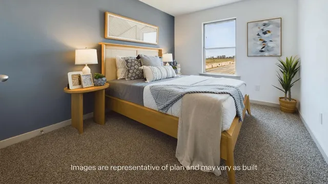 a spacious bedroom with a bed and a large window