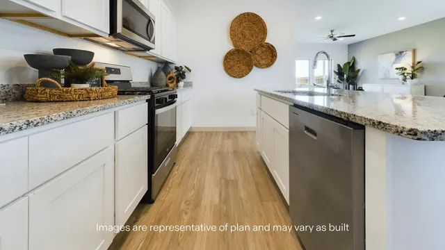 a kitchen with sink and cabinets
