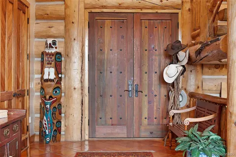 a living room with furniture a large window and a chandelier