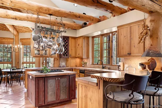 a kitchen with a refrigerator and a stove