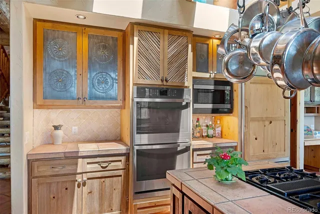 a spacious bedroom with a bed a couch and large windows