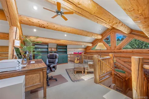 a work room with furniture and large windows