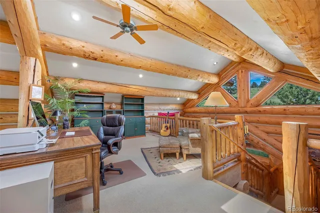 a work room with furniture and large windows