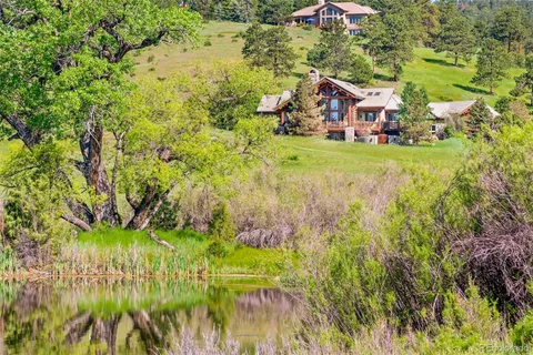 a bathroom with a granite countertop sink a toilet and a mirror