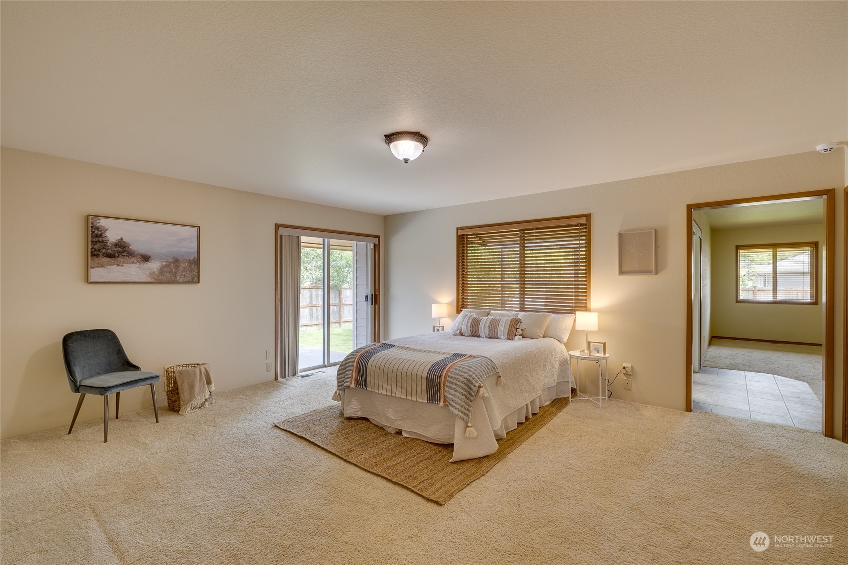 801 Main Street Sultan, WA 98294 - Photo 12 of 40 a bedroom with a bed and a chair next to a window