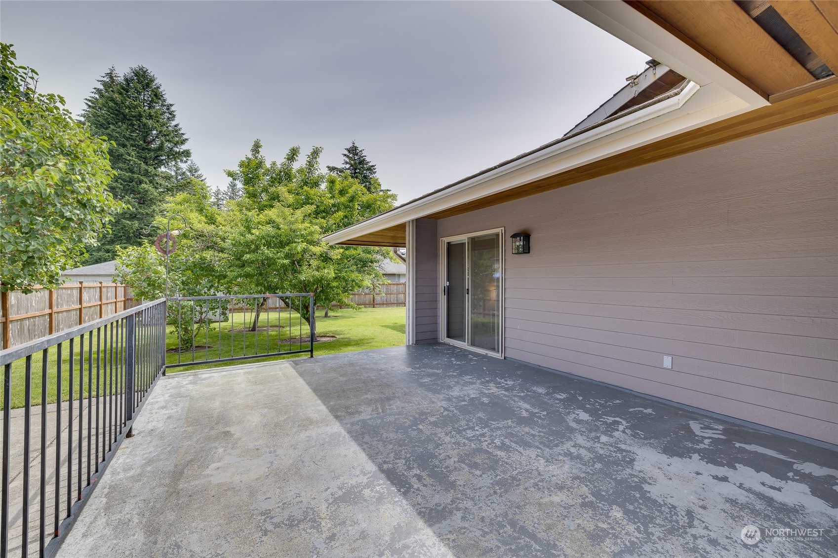 801 Main Street Sultan, WA 98294 - Photo 31 of 40 a view of a house with a small yard and floor to ceiling window and wooden fence