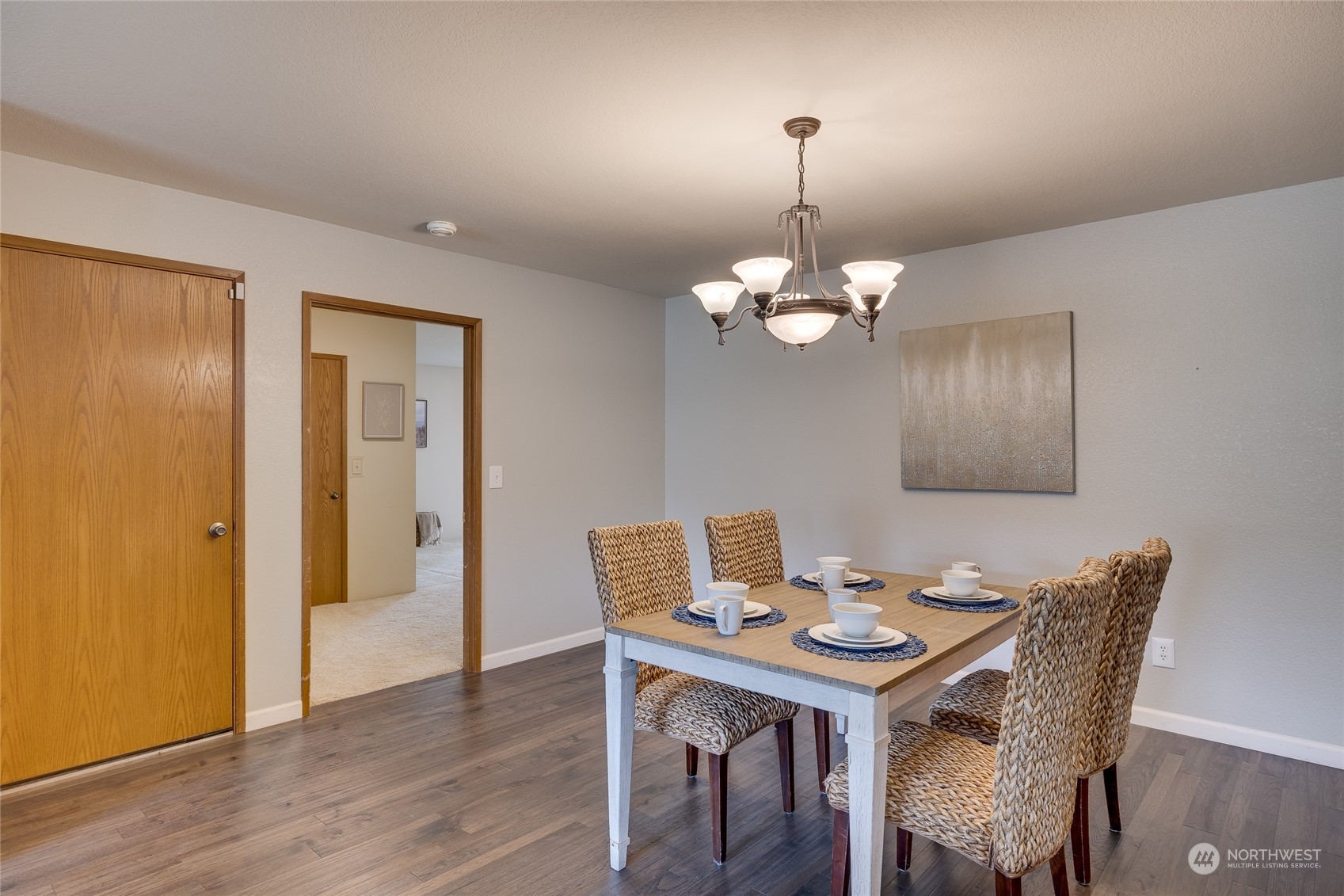 801 Main Street Sultan, WA 98294 - Photo 7 of 40 a dining room with wooden floor a chandelier a wooden table and chairs