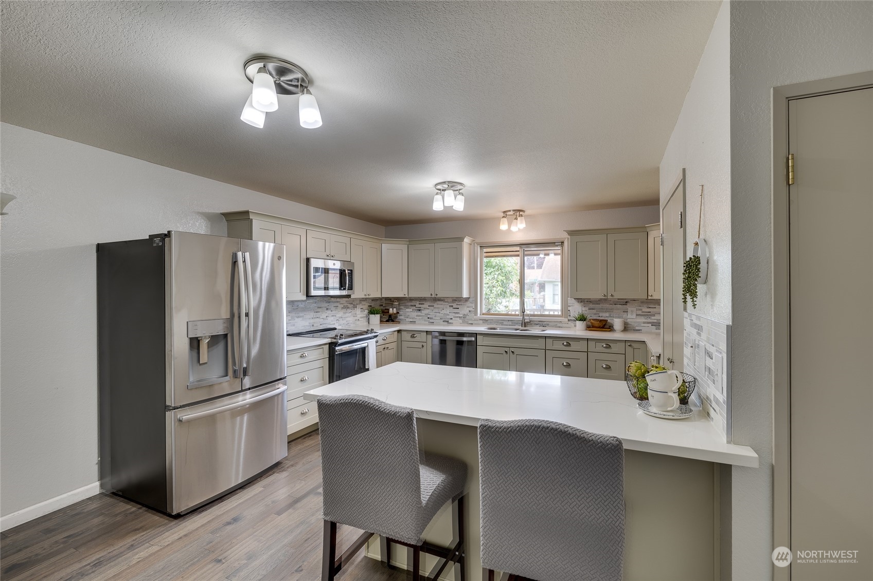 801 Main Street Sultan, WA 98294 - Photo 9 of 40 a kitchen with refrigerator and cabinets
