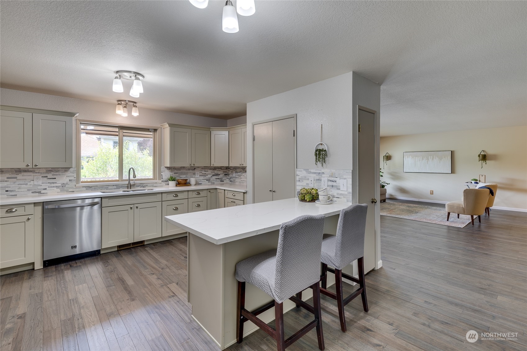 801 Main Street Sultan, WA 98294 - Photo 10 of 40 a kitchen with a dining table chairs refrigerator and cabinets