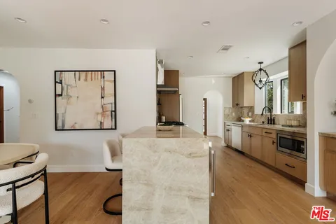 a kitchen with stainless steel appliances a stove top oven and a refrigerator