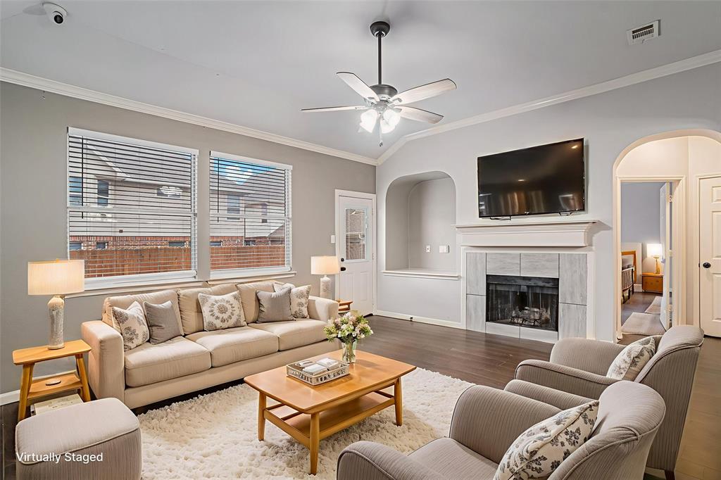 10005 Shelburne Road Fort Worth, TX 76244 - Photo 11 of 26 a living room with furniture a flat screen tv and a fireplace